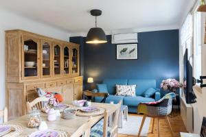 a living room with a blue couch and a table at Maloan, gite avec piscine in Saint-Julien-de-Lampon