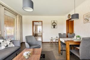 a living room with a table and chairs at Ferienwohnung Sawade Schafstedt in Schafstedt