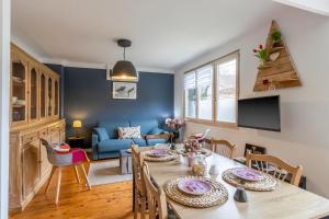 a dining room and living room with a table and chairs at Maloan, gite avec piscine in Saint-Julien-de-Lampon