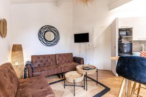 a living room with a couch and a table at Maisonnette Biscarosse in Biscarrosse +15 photos