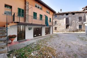 an old building with a balcony and a courtyard at La Corte Di Zio Pippo in Albavilla