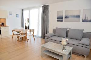 a living room with a couch and a table at Apartment Olperer in Mühlbachl