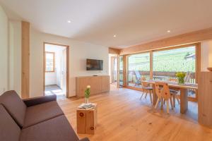 a living room with a couch and a table at Moosbichlerhof in Marlengo