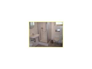 a bathroom with a sink and a toilet at Äckerhof in Wolfach +35 photos