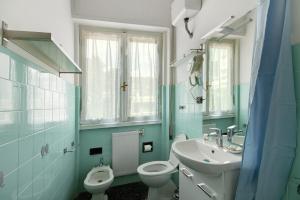 a bathroom with a white toilet and a sink at Casa Dica in Rapallo +10 photos