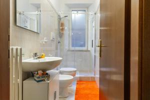 a bathroom with a sink and a toilet and a shower at Appartamento Onda d'argento in Porto Santo Stefano +18 photos