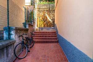 a bike parked on a brick walkway with stairs at Appartamento Onda d'argento in Porto Santo Stefano