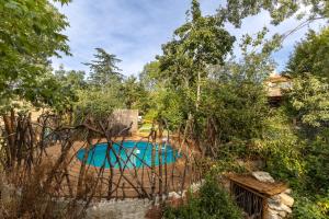 a swimming pool in a yard with trees at Dalt La Figuera in La Higuera