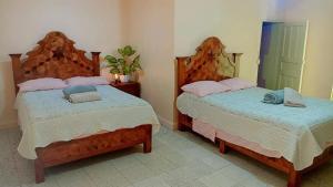 two beds sitting next to each other in a bedroom at Tranquilidad y comodidad in Dolores Hidalgo +37 photos