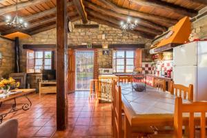 a kitchen with a large wooden table in a room at Apartamento Juntana 2 in Villacarriedo