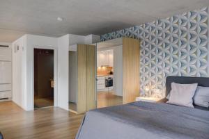 a bedroom with a large bed and a kitchen at Ferienwohnung Frieda in Frickingen