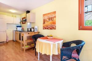 a kitchen with a table and chairs and a table and a kitchen gmaxwell gmaxwell gmaxwell at Hach in Sulzburg