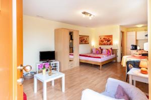 a hotel room with a bed and a living room at Hach in Sulzburg