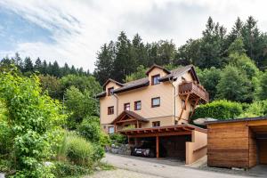 a house on the side of a hill with trees at Hach in Sulzburg