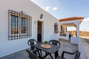 a patio with a table and chairs on a porch at Citronela in Níjar