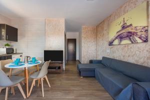 a living room with a blue couch and a table at Citronela in Níjar