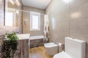 a bathroom with a toilet and a sink and a tub at Citronela in Níjar +12 photos