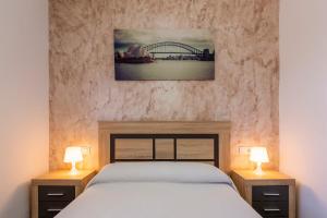 a bedroom with a bed with two lamps on it at Citronela in Níjar