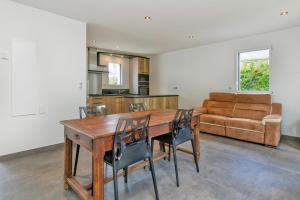a kitchen and dining room with a wooden table and chairs at Villa Ker Minet - Hoedic - 6 pers in Piriac-sur-Mer