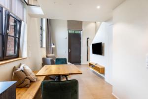 a living room with a wooden table and chairs at Die Ferienwohnung in Reichenau