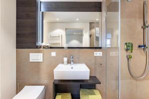 a bathroom with a sink and a mirror at Die Ferienwohnung in Reichenau +37 photos