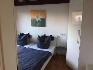 a bedroom with two beds with blue pillows at Ferienwohnung Schwahn in Kleinschönach