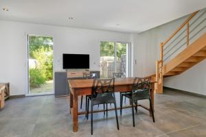 a dining room with a wooden table and chairs at Villa Ker Minet - Hoedic - 6 pers in Piriac-sur-Mer