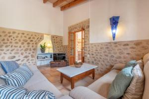 a living room with a couch and a table at Finca Ca'n Vaqueta in Sóller