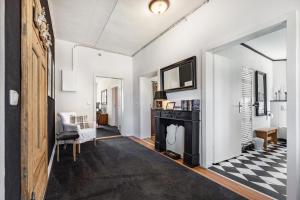 a living room with a fireplace and a black and white checkered floor at Landhaus Heiddorf in Neu Kaliß