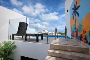 a chair sitting on the balcony of a house at Luxury Penthouse with Ocean Views and Private Pool in Playa del Carmen