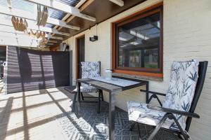 a table and two chairs on a patio at Auszeit an der Eider in Hennstedt