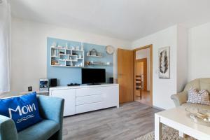 a living room with a tv and a couch at Auszeit an der Eider in Hennstedt