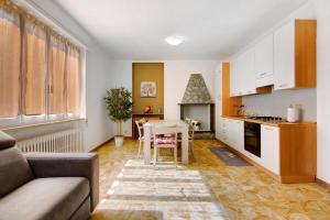 a living room with a table and a kitchen at Gravedona Lake Como in Consiglio di Rumo