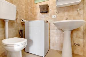 a bathroom with a white toilet and a sink at Gravedona Lake Como in Consiglio di Rumo +13 photos