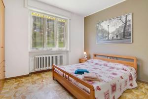 a bedroom with a bed and a window at Gravedona Lake Como in Consiglio di Rumo
