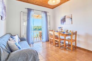 a living room with a couch and a table with a dining room at Dolphin villa 1 in Gaios
