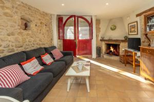 a living room with a couch and a fireplace at Casa Vermella in Orriols