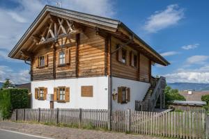 an old wooden house with a fence at Bergchalet Fuchsberger in Verano +15 photos