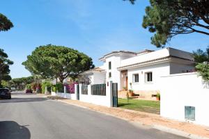 a white house on the side of a street at Sol, playa y diversion en Roche in Roche