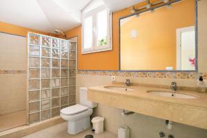 a bathroom with two sinks and a toilet and a mirror at Sol, playa y diversion en Roche in Roche +22 photos