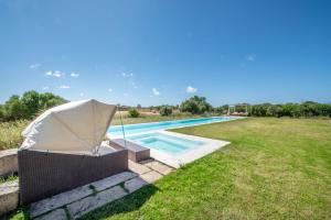 a tent sitting next to a swimming pool at Son Coranta in Campos