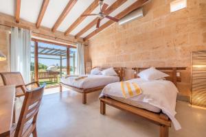a bedroom with two beds and a table and chairs at Son Coranta in Campos +19 photos