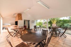 a patio with tables and chairs and a kitchen at Bosque São José Ag in Olhos de Água