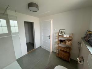 a bathroom with a shower and a glass door at Landhausappartment in Bermatingen