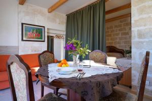 a dining room with a table with a bowl of fruit on it at La Casa di Marta in Faccia di Trippa