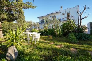 a table and chairs in the yard of a house at La Casa di Marta in Faccia di Trippa