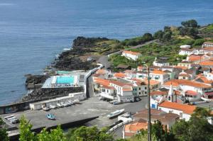 a group of buildings on a hill next to the ocean at Pico Boutique House in Lajes do Pico