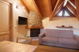 a living room with a couch and a fireplace at Il Piccolo Sogno in Temù