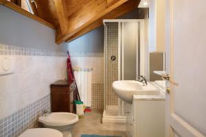 a bathroom with a toilet and a sink at Il Piccolo Sogno in Temù +14 photos