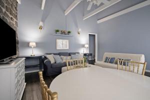 a living room with a couch and a tv at Pico Boutique House in Lajes do Pico +27 photos
